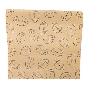 May include: A sheet of light brown kraft paper featuring a repeating pattern of black line art illustrations of American footballs. Each football graphic includes the characteristic laces and stripes, arranged in various orientations across the surface.