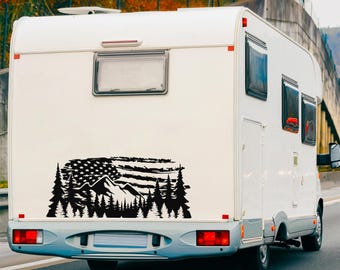 May include: A white camper van with a black and white decal of a mountain scene with a distressed American flag on the back.