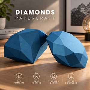 May include: Two blue papercraft diamond sculptures with geometric, faceted surfaces. The text DIAMONDS PAPERCRAFT appears above the objects, with icons below for PDF template, easy to make, stunning decor, and instant download features.