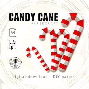 May include: A digital download DIY pattern for papercraft candy canes. The image features several red and white striped candy canes in a 3D geometric design. Text includes "CANDY CANE PAPER CRAFT", "A4", "PDF DOWNLOAD", and "LASER FORM DESIGN".