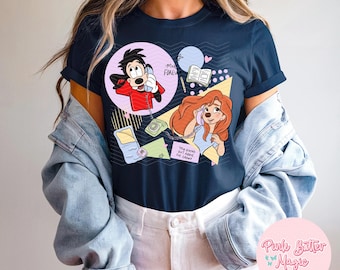 May include: Navy blue t-shirt featuring cartoon illustrations of Max and Roxanne on the phone. Max is in a red jacket, and Roxanne is in a blue top. The shirt has the text "M+R Forever" and "You Stand Out Above The Crowd".