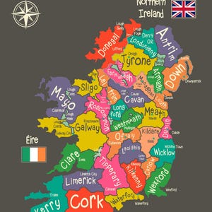 May include: A colourful map titled Counties and Capitals of Éire and Northern Ireland on a dark grey background. It displays the counties of Ireland in various colours with white text labels for counties and capitals, a compass rose, and flags.