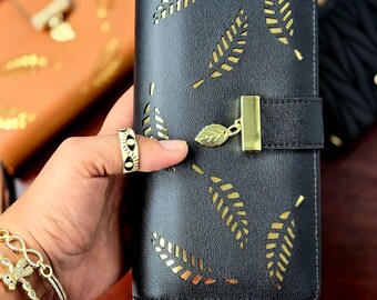 Long clutch purse with card compartments and cell phone compartment. Zipper closure. Very good quality.