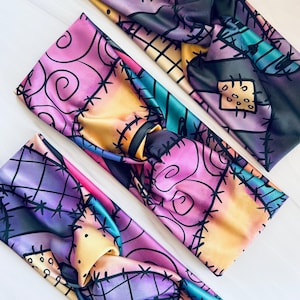 May include: Three colorful fabric headbands with a patchwork design featuring a character from the movie "The Nightmare Before Christmas".