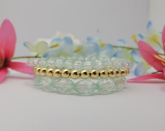 Luxurious bracelet jewelry with blue crystals of varying sized and gold bracelet accent in the middle,