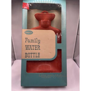 May include: A red rubber hot water bottle in its original box. The box is teal and features the words "Family WATER BOTTLE" in a wooden-style font. The brand name "DAVOL" is also visible.