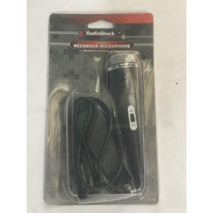 May include: A RadioShack universal recorder microphone in its original packaging. The microphone is black with a silver mesh head and an on/off switch. The packaging is grey and red.