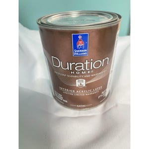 May include: A can of Sherwin-Williams Duration HOME interior acrylic latex paint. The can is brown with white text that reads "Duration HOME" and "Excellent Durability and Washability". The can also has a "Lifetime Limited Warranty".