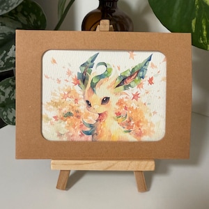 May include: A watercolor painting of a light brown Eevee Pokemon with green leaves on its head. The background is a light orange with white and light brown spots.