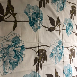 May include: White fabric with a repeating pattern of teal blue and brown floral designs. The flowers are stylized peonies with a detailed outline.