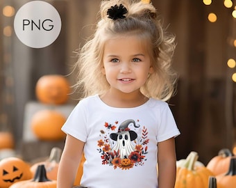 May include: A white short-sleeved t-shirt featuring a graphic of a ghost wearing a witch hat surrounded by orange and red autumn flowers and a small pumpkin. The shirt is paired with a black tulle skirt. The image includes the text PNG and Instant download.
