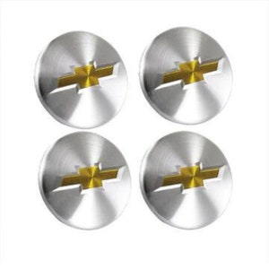 May include: Four silver car hubcaps with a gold Chevrolet logo in the center.