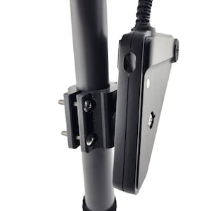 May include: Black metal mount with screws for attaching a device to a pole or rail.