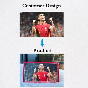 May include: An embroidered patch featuring a football player celebrating a goal, with red and green colours. The patch is framed with a red border and white stitching.