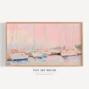 May include: A framed painting of sailboats in a harbor. The artwork features a soft color palette of pink, blue, and beige. The painting has a wooden frame and the text "NINI ART BRUSH" and "HERITAGE PRINTS ARTISTRY" at the bottom.