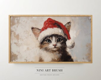 May include: A painting of a cat wearing a red Santa hat. The cat is looking at the viewer with a curious expression. The background is a light gray with a hint of blue. The painting is framed in a light wood frame.