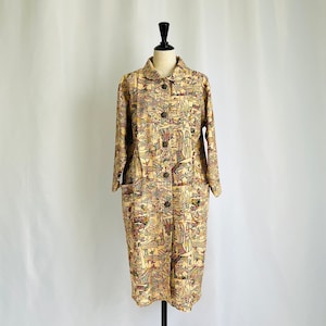 May include: A long, beige coat with a colourful, patterned design. The coat has a button closure and two pockets.