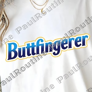 May include: White t-shirt with the text "Buttfingerer" in blue and yellow. The shirt is a casual style, with short sleeves. The text is centered on the front of the shirt.