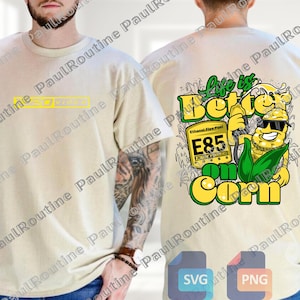 Op de afbeelding: Beige T-shirt met een geel rechthoekig ontwerp op de voorkant. De achterkant van het shirt heeft een afbeelding met de tekst "Life is Better on Corn" en een cartoon maïskarakter met zonnebril en een benzinepomp.
