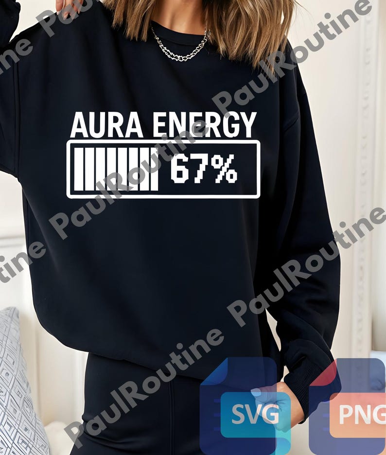 A person wearing a black sweatshirt with the text "Aura Energy 67%" printed on it.