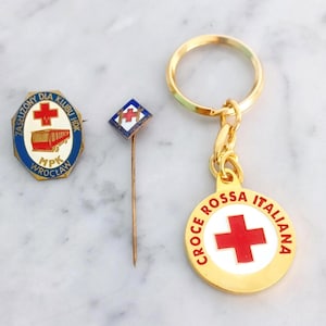 Red Cross memorabilia 1 jacket pin of Croce Rossa Italy 1940s, one keychain of Italian Red Cross, one pin of the Red Cross in Poland 1960s