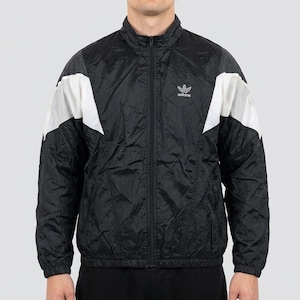 May include: A black zip-up track jacket featuring a high collar, long sleeves with white mesh paneling on the shoulders, and a white Adidas trefoil logo with the text adidas printed on the upper left chest area of the garment.