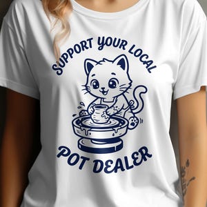 May include: A white ceramic mug with a black handle and the text "But First, Coffee" in a bold, black font. The mug is set against a blurred background, suggesting a cozy setting.