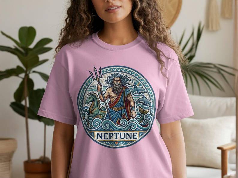 Pink t-shirt with circular Neptune design featuring a merman, horses, and dolphins.