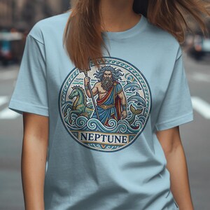 Light blue t-shirt featuring a circular mosaic of Neptune with a trident and horse.