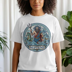 Circular graphic on white t-shirt depicting Neptune with trident and horses.