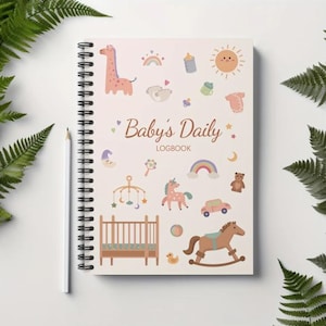 Puede incluir: Una libreta de espiral rosa y blanca con el título "Baby's Daily Logbook" e ilustraciones de juguetes para bebés, animales y otros artículos relacionados con bebés.