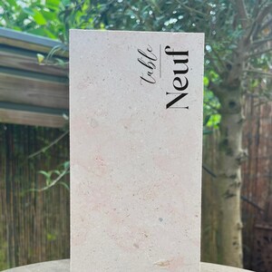 Peut inclure: Un numéro de table rectangulaire beige clair avec le mot "Neuf" et le mot "Table" écrits en cursive noire.