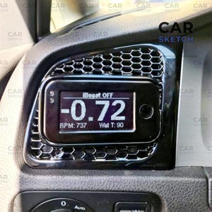 May include: A black car dashboard with a digital display showing "-0.72", "RPM: 737", and "Wat T: 90". The display reads "iBoost OFF". The dashboard has a honeycomb grill design and the text "CAR SKETCH".