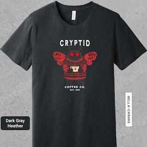 a black t - shirt with a picture of a cup of coffee on it