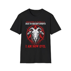 May include: A black short-sleeved t-shirt featuring a graphic of a goat head centered within a red pentagram. Above the goat is the text "DUE TO RECENT EVENTS" and below is "I AM NOW EVIL" in red, with Japanese text above the English.