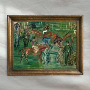 May include: An impressionistic painting in a gold frame depicts a horse race scene. The artwork features horses, jockeys, and spectators in a vibrant, colorful style. The painting has a green background and a signature in the bottom left corner.