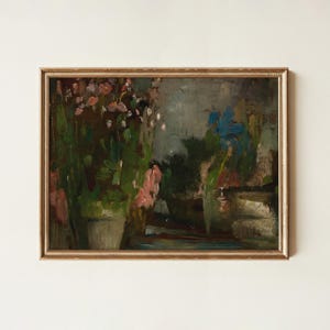 May include: A framed oil painting featuring a dark, moody landscape with a cluster of pink and white flowers in a pot on the left, deep green foliage, and a muted blue sky, all enclosed within a thin, metallic gold-toned rectangular frame.