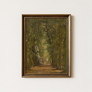 May include: A framed oil painting depicting a forest path lined with tall, dark green trees. The ground is covered in fallen brown leaves, and light filters through the dense canopy, creating a soft, dappled effect along the center of the trail.
