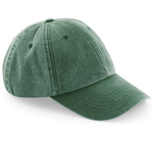 Puede incluir: Una gorra de b&eacute;isbol de algod&oacute;n verde, sin estructura, con visera curva.