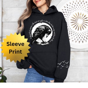 May include: Black hoodie with a crow graphic and the text "Black bird singing in the dead of night. Take these broken wings and learn to fly."