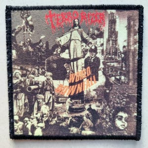 May include: Square patch with a black border. The sepia-toned design features a figure with outstretched arms, a cityscape, and the words "TERROR RIDER" and "WORLD DOWNFALL" in red and orange.