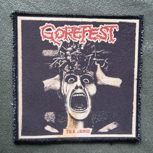 May include: Square patch with a black background featuring the red text "GOREFEST" above a screaming face graphic. The graphic includes a person with their hands on their head and the text "THE DEMOS" below.