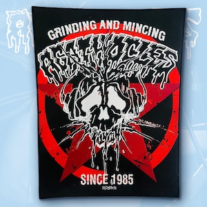 May include: A rectangular black fabric patch featuring a red star graphic and a white skull wearing headphones. The text reads GRINDING AND MINCING, AGATHOCLES, and SINCE 1985. The design includes white dripping paint effects and black splatter details.