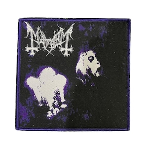 May include: Square black patch with a purple border. The patch features the band name "Mayhem" in white gothic lettering at the top. Below are two white figures with a purple background.