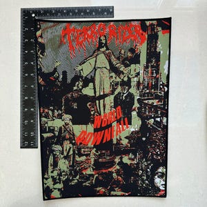 May include: A rectangular patch with a collage design. The patch features the words "TERRORIZER" and "WORLD DOWNFALL" in red, with a central image of a figure with outstretched arms. The background is a mix of green, black, and red.