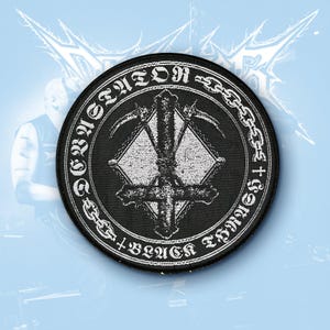 May include: A circular black embroidered patch featuring a white graphic of an inverted cross intertwined with two scythes inside a diamond shape. The border contains the text DEVASTATOR and BLACK THRASH separated by chain links and crosses.