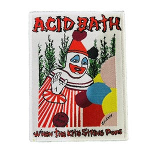 Op de afbeelding: Geborduurde patch met een clown in rood-wit gestreepte kleding, een rode hoed en een geschilderd gezicht. De patch heeft de woorden "ACID BATH" en "WHEN THE KITE STRING POPS" in rode tekst. Een cluster van kleurrijke vormen staat rechts.