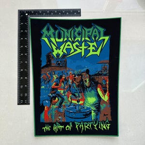 May include: A black patch with a green border featuring the band name "MUNICIPAL WASTE" in green and blue lettering. The image depicts a crowd of people partying with the text "THE ART OF PARTYING" below.