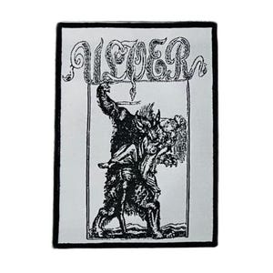May include: A rectangular fabric patch featuring a black and white graphic illustration of a wolf-like creature carrying a person. The text ULVER is printed in a stylized font at the top. The design is enclosed in a thin black border on a white background.