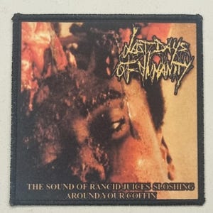 May include: Square patch with a black border. The image features the text "LAST DAYS OF HUMANITY" in a distressed font. The background is dark reddish-brown, with the text "THE SOUND OF RANCID JUICES SLOSHING AROUND YOUR COFFIN."